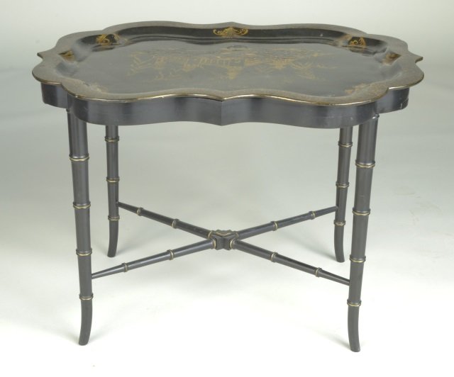 Papier Mache Tray Table: Gilt decoration, on a black painted faux bamboo base. Height 22 1/2 inches, width 30 inches, depth 24 inches.