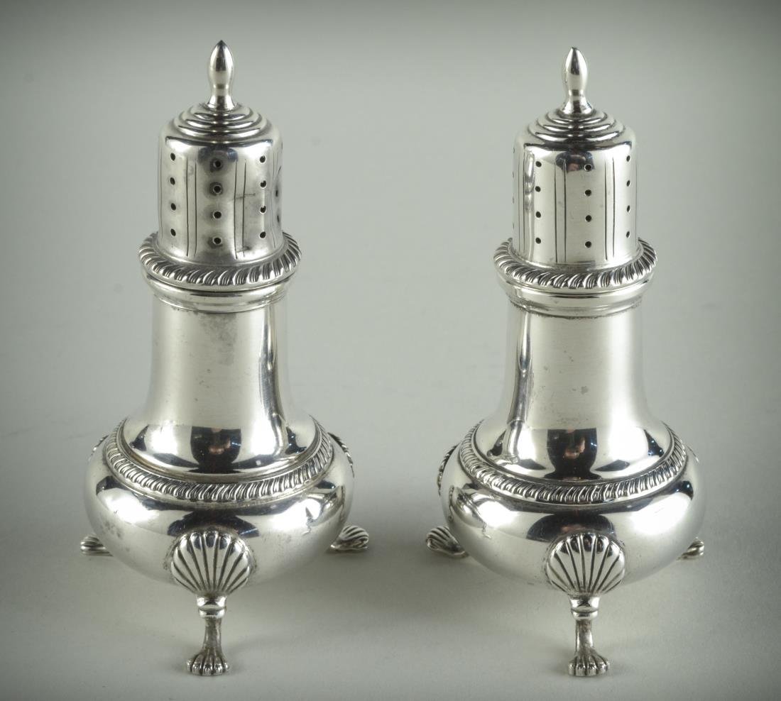 Pair of Fisher Sterling Silver Casters: Each with flame finial, baluster body with gadroon decoration and shell capped scroll feet. Height 4 1/2 inches, 5 ounces.