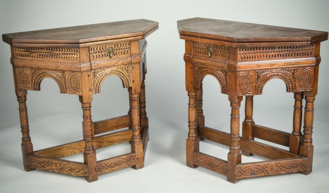 Pair of Oak Fold Top Tables: Each with rectangular top with cut front corners over a single drawer and heavily carved apron, turned legs joined by a box stretcher. Height 30 1/2 inches, width 34 inches, depth 17 inches.
