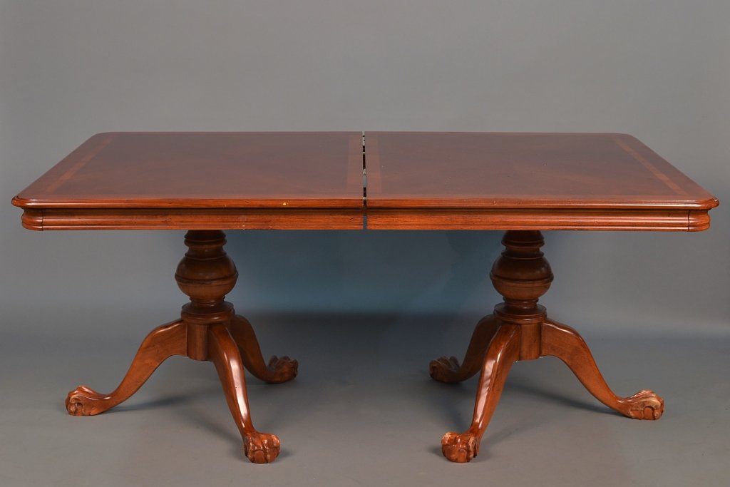 Double Pedestal Extension Dining Room Table: Rectangular crossbanded top with rounded corners, on two pedestals each with turned support on three scroll legs ending in ball and claw feet, with two additional leaves. Height 30 inches, length exte