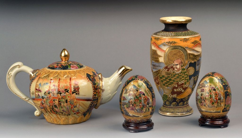 Group of Four Japanese Porcelain Decorations: Comprising a vase, a teapot and two eggs. Vase, height 10 1/2 inches.