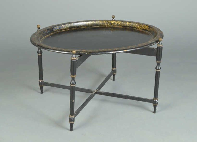 Papier Mache Tray Table: Oval tray with gilt border with Asian theme decoration on a folding base. Height 20 inches, width 30 1/2 inches, depth 23 inches.