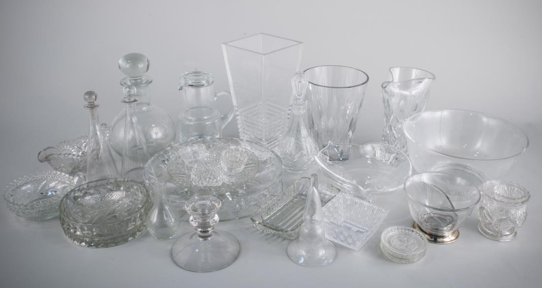 Group of Colorless Glass Table Decorations: Including a Steuben bowl, a Revere bowl, four stoppered bottles, two pairs of salt cellars, vases, cut glass bowls, pitcher, etc. Tallest vase, height 10 3/4 inches.