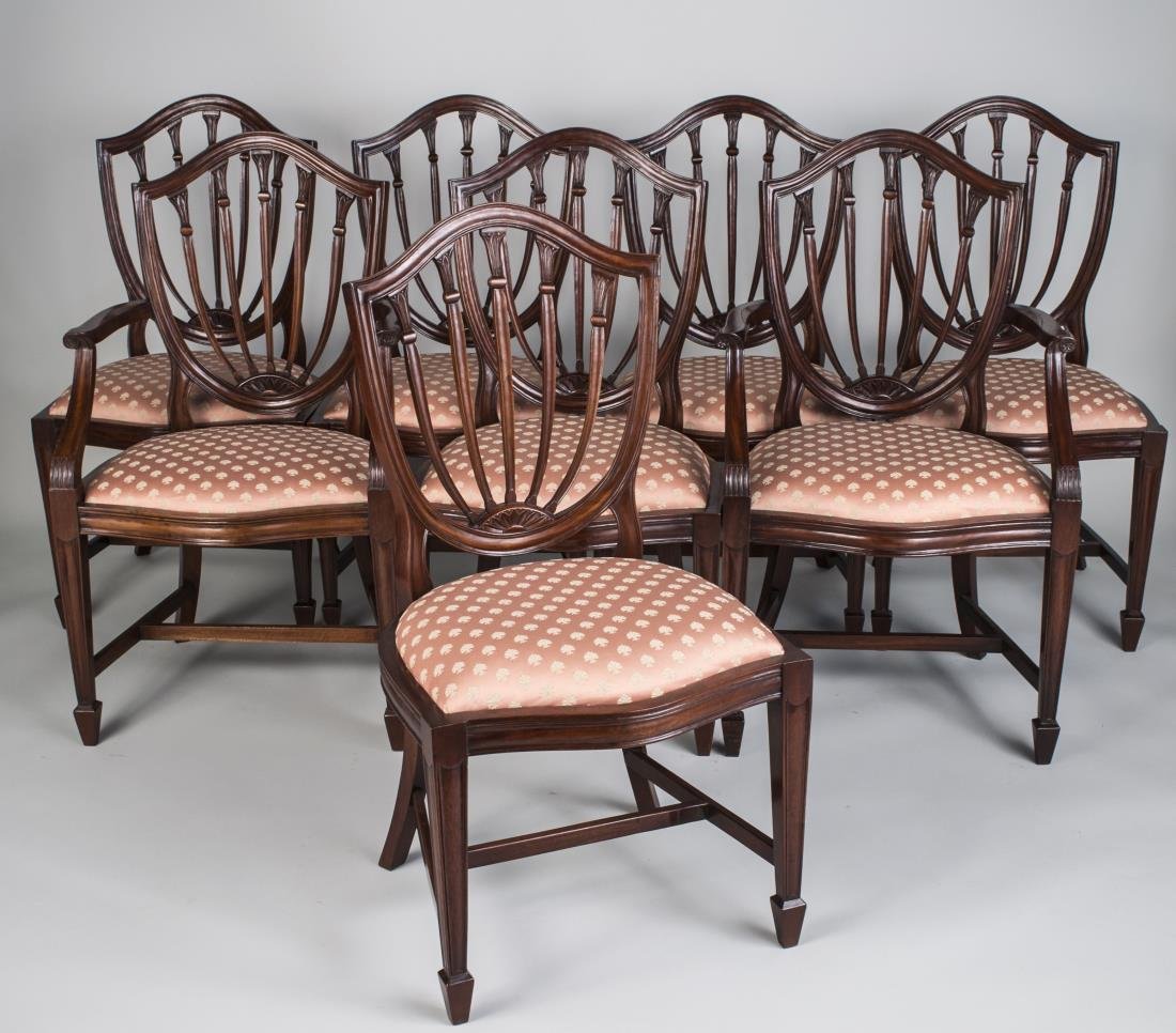 Set of Eight Hepplewhite Dining Room Chairs: Each with shield back, upholstered seat and square tapered legs. Height 38 1/2 inches, width 21 inches, depth 21 inches.