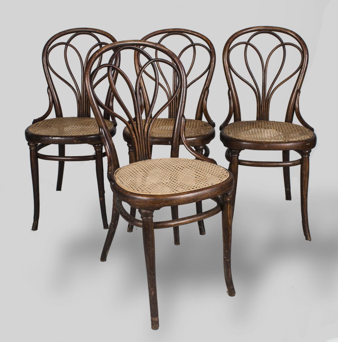 Set of Four Thonet Side Chairs: Bent wood backs and caned seats. Height 36 inches, width 17 1/2 inches, depth 19 inches.
