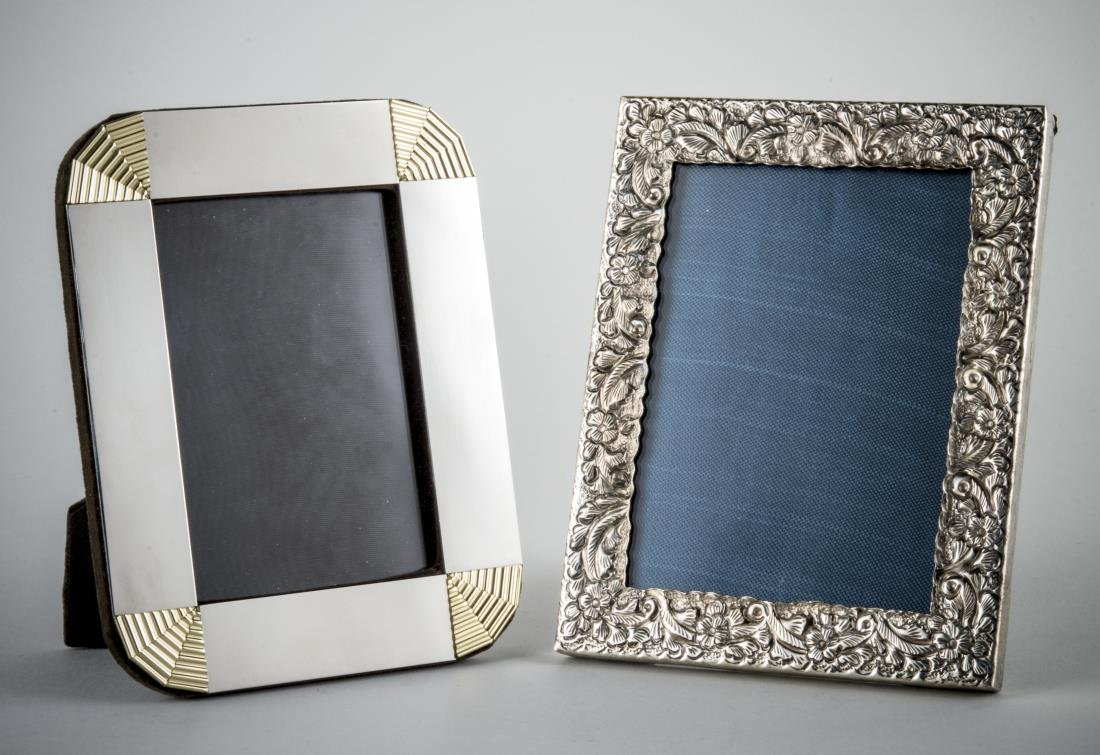 Two Silver Picture Frames: One with repousse floral decoration; the other modern design with brass corners. Both for 5 x 7 pictures.