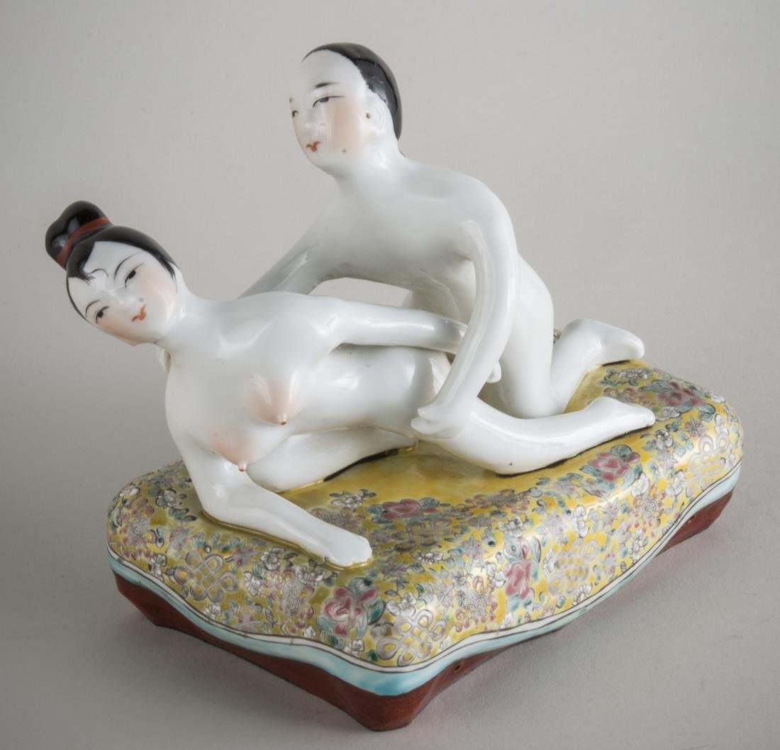 Chinese Porcelain Erotica Figure: Circa 1920, modelled as two figures in an embrace on a famille jaune cushion, marked on the bottom. Height 6 1/2 inches. Provenance: From a Pennsylvania Private Collection.
