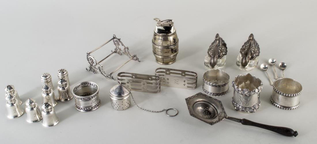 Misc Group of Sterling Articles: Including Tiffany & Co. Makers barrel form table lighter, group of individual shakers, salt cellar spoons, napkin rings, tea strainers, etc., together with a pair of .835 silver swan salt cellars. 336