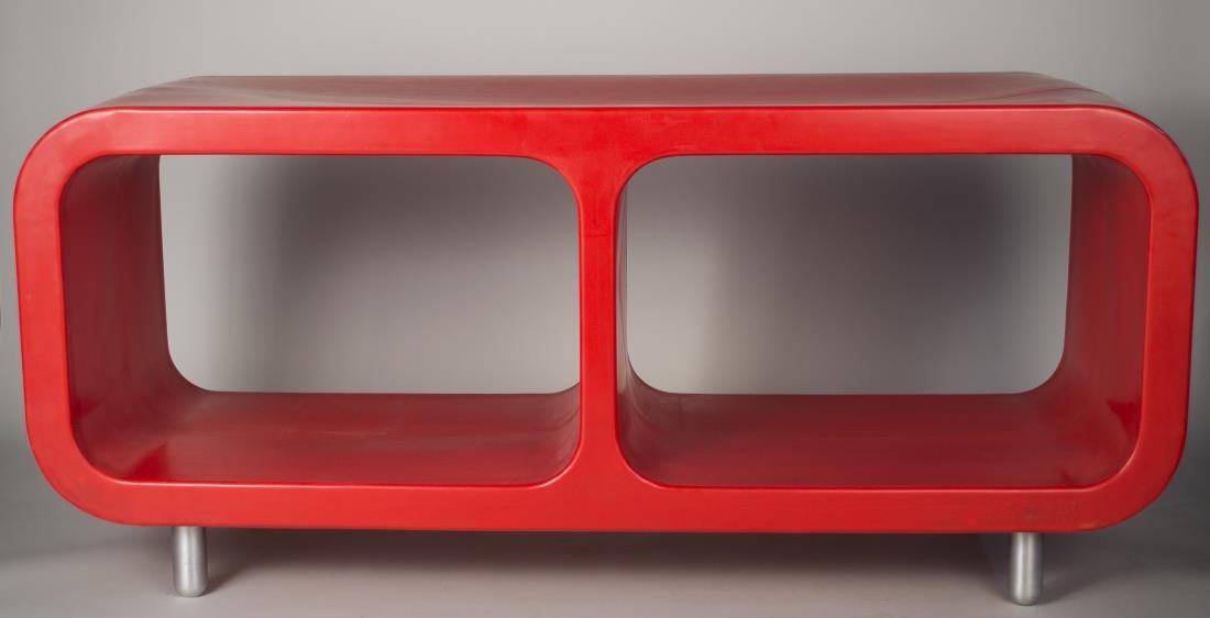 Marc Newson W< Open Shelf: Red polypropylene with aluminum machined legs, labeled. Height 34 inches, width 6 feet, depth 25 1/2 inches.