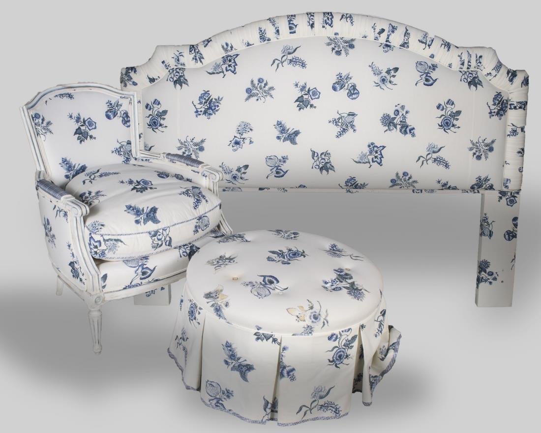 White Painted Bergere, Ottoman & Headboard: Blue flowers on white fabric, comprising a lounge chair and ottoman, with a matching upholstered headboard. Height 35 inches, width 27 inches, depth 28 inches