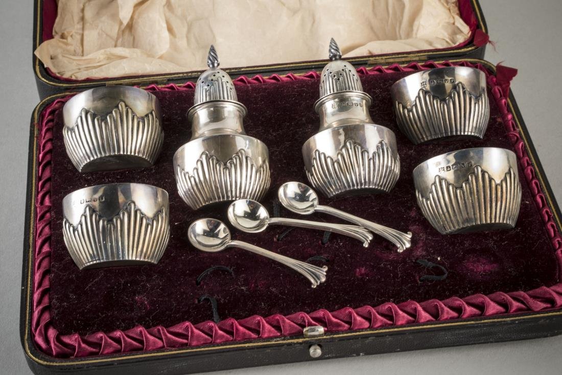 Victorian Silver Caster Set: Maker's mark JDWD, Sheffield, 1888, comprising a pair of casters, four salt cellars and three associated salt spoons, in original fitted box. Total 160 grams