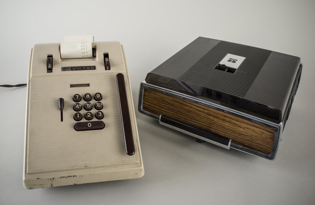 Vintage Adding Machine and Projector: Including a Victor adding machine and a Kodak carousel projector, both with carrying cases.