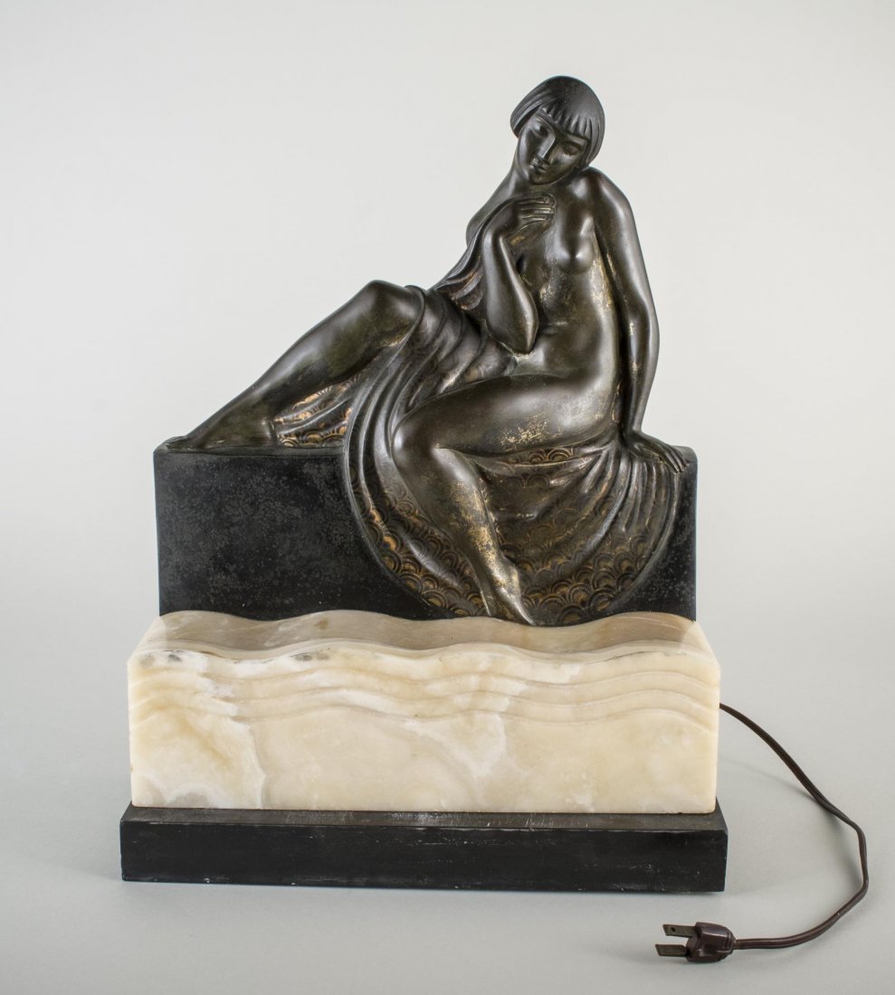 Abel R. Philippe (French ) Art Deco Lamp: Patinated bronze female figure seated, on a cream marble base, signed on the back, 'A R. Philippe'. Height 16 1/2 inches.