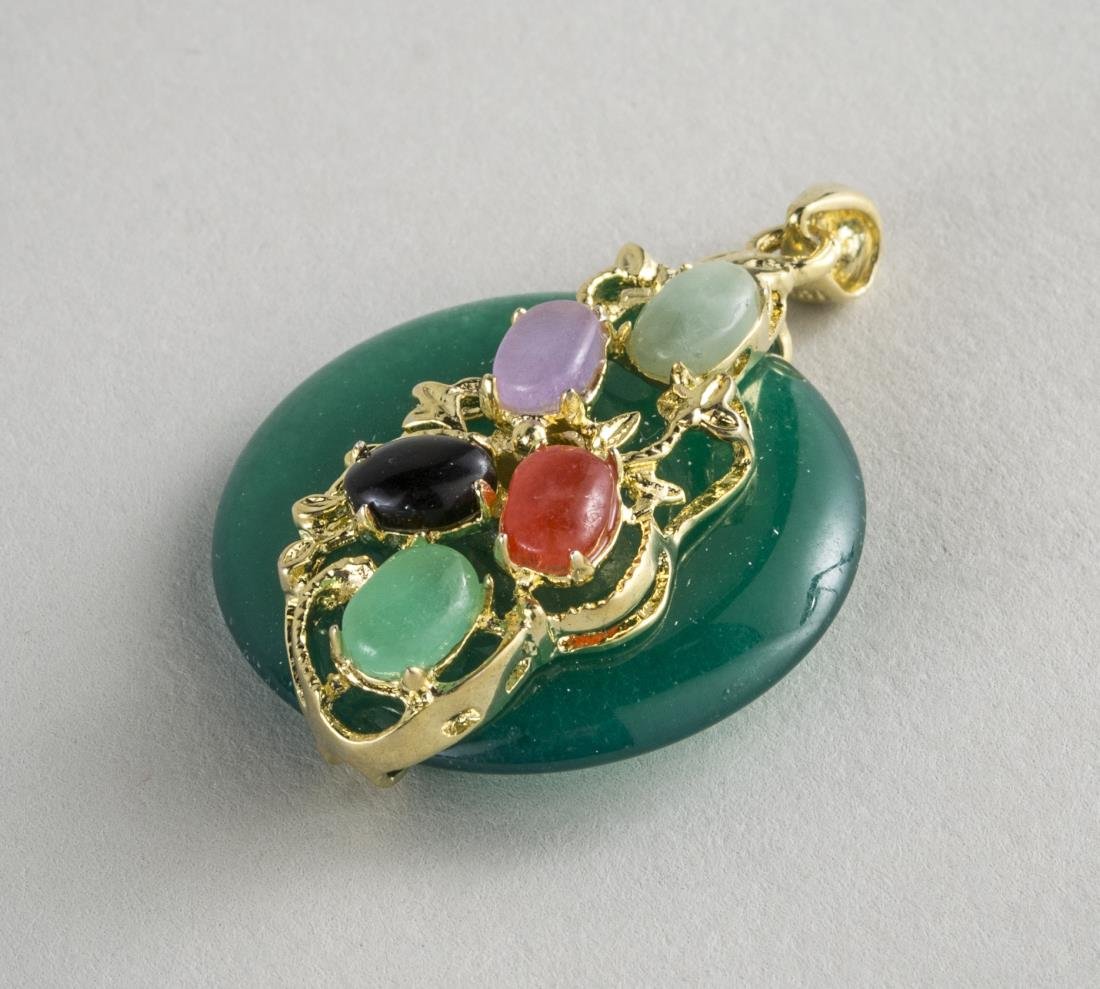 Jade Pendant: Set with carnelian and jadite cabochons.