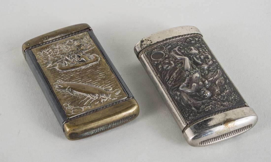 Two Match Safes: One, white metal safe marked 'Compliments of John A McLain'; and the other marked 'Wolf & Ulrich, Chicago' Larger, length 2 7/8 inches,