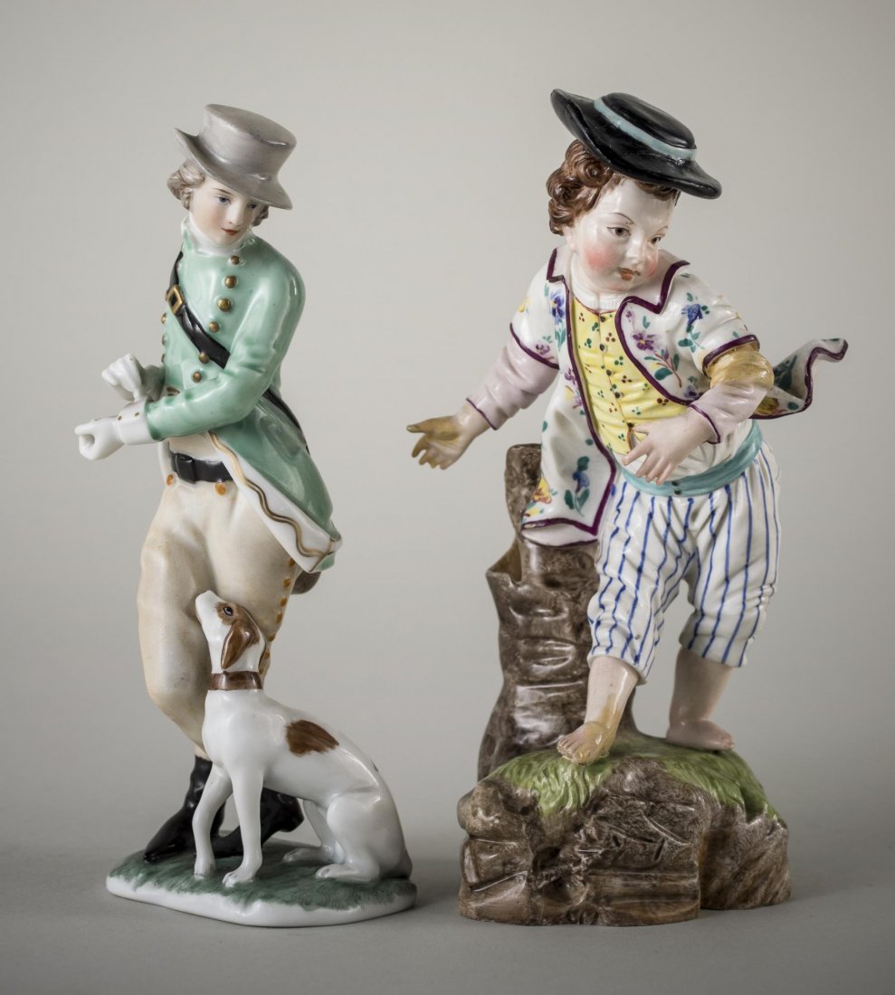 Two German/Austrian Porcelain Figures: One, Hochst 19th century, figure of a boy wearing blue striped trousers, a vest and waistcoat and a black hat, height6 1/4 inches; the other a Vienna figure of a boy with a dog, height 6 inches.