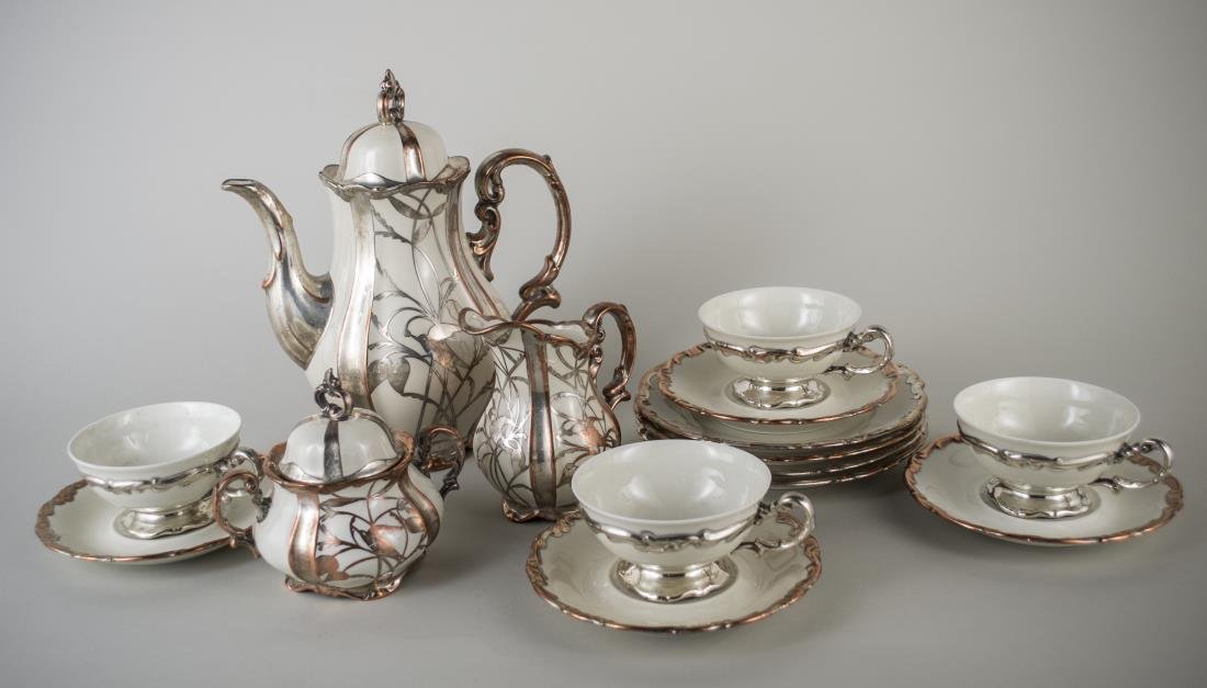 Bavarian Silver Overlay Porcelain Dessert Set: Comprising a coffee pot, milk jug, sugar and four cups and saucers. Coffee pot, height 10 1/2 inches.