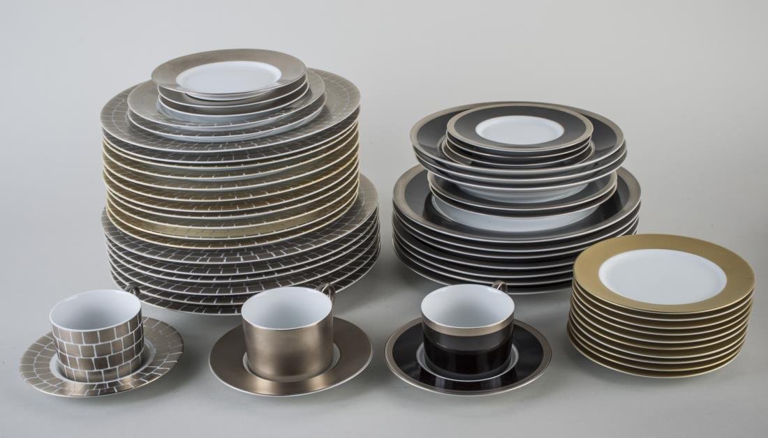 Group of Marc Blackwell Porcelain Dinnerware: Approximately sixty three pieces, in three patterns including Tuxedo, Palazzo, and Florentine in gold and platinum, comprising six chargers, eighteen dinner plates, four salad plates, thirteen bread p