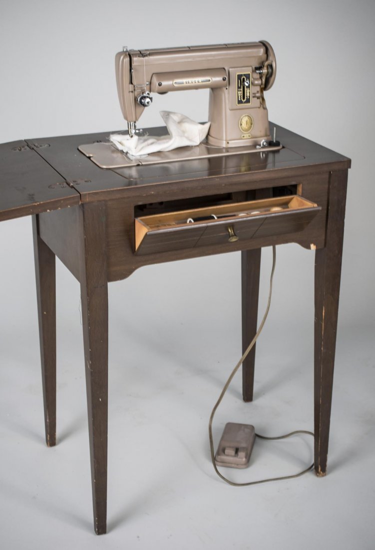 Singer Sewing Machine: In a cabinet. Height 41 inches, width 46 inches, depth 18 inches.