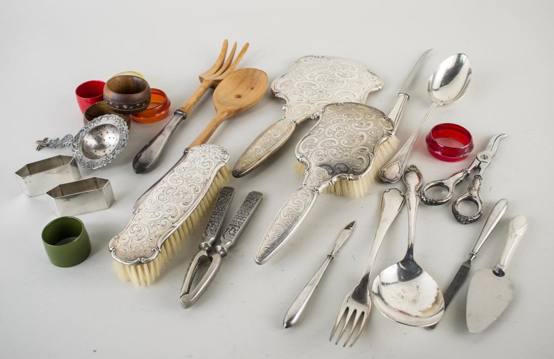 Group of Silver and Silver Plated Articles: Including a Continental hand mirror and hair brush, marked .835 with engraved scroll and flower decoration, together with a sterling handled salad set and other assorted flatware pieces, a pair of nap