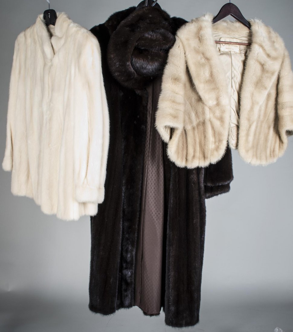 Three Lady's Furs: Full length dark brown mink coat, white mink jacket and a champagne stole.