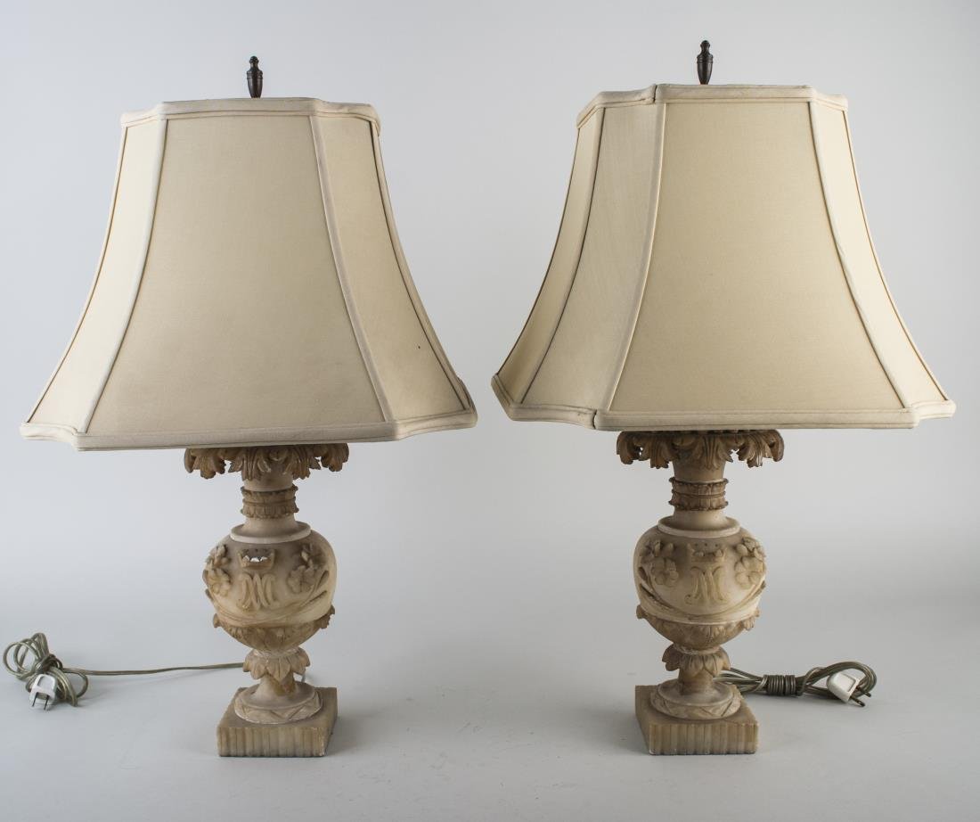 Pair of Alabaster Lamps: Urn shaped two light lamps with carved acanthus leaf decoration. Height 18 inches.