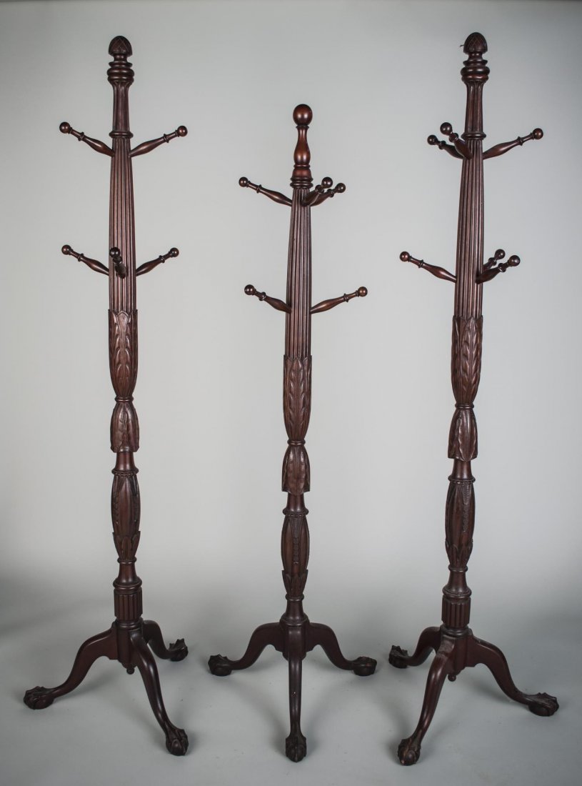 Three Geroge III Style Mahogany Coat Racks: Each carved wood with two hanging tiers and tripod bases. Tallest, height 6 feet.