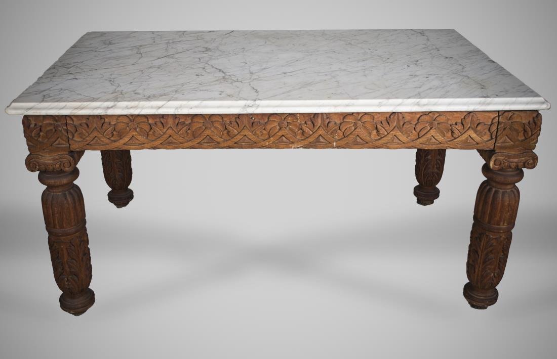 Marble Top Bakers Table: Rectangular grey veined white marble top with molded edge on a carved wood base. Height 30 inches, width 60 inches, depth 38 inches.