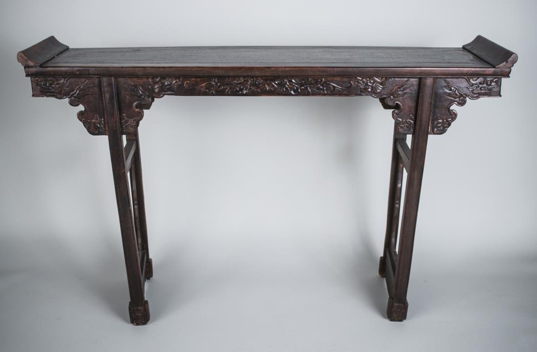 Asian Carved Rosewood Altar Table: Rectangular top with upturned ends on two openwork supports. Height 37 inches, width 5 feet, depth 15 inches.