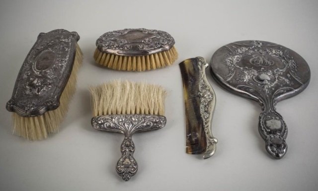Sterling Silver Assembled Dresser Set: Including two sterling silver clothes brushes, hand mirror, another brush and a comb.