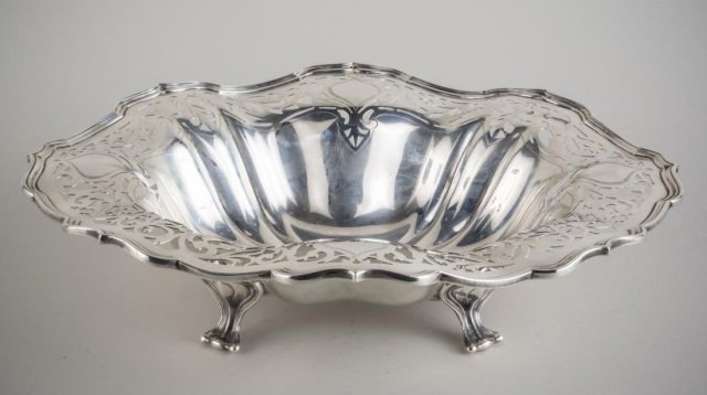Mauser Sterling Silver Footed Bowl: Shaped oval, with reticulated scroll border. Height 4 1/2 inches, length 16 inches, 37 ounces.