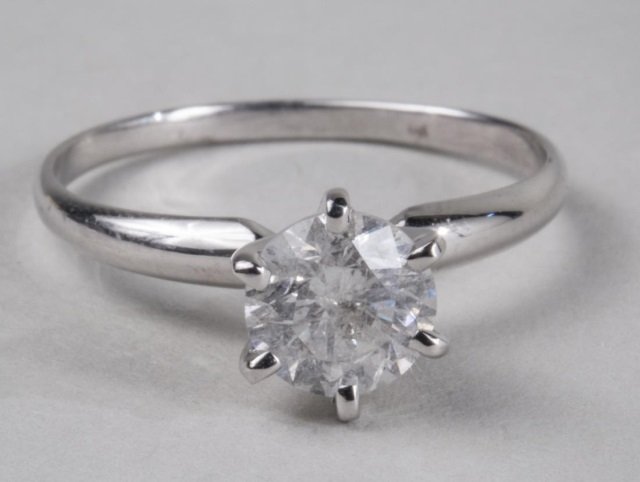 Diamond Solitaire: 14k white gold ring with a round diamond weighing approximately 1 carat. Size 6 1/2.