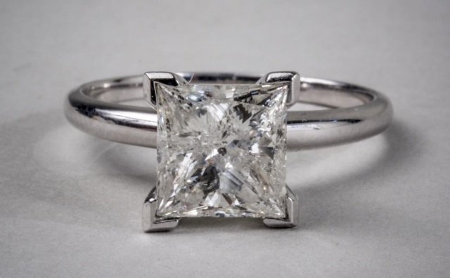 Diamond Solitaire: 14k white gold with a square diamond weighing approximately 2.0 carats. Size 5 1/2.