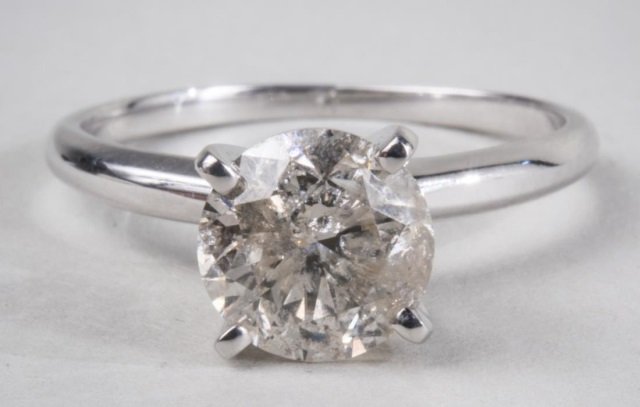 Diamond Solitaire: 14k white gold ring with a round diamond weighing approximately 1.50 carats. Size 5 1/2.