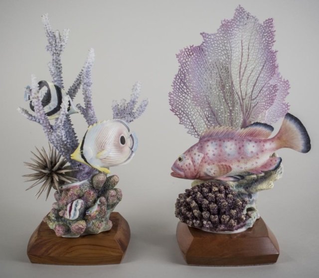 Two Royal Worcester Porcelain Fish Sculptures: Including a Red Hind numbered 168/500, and a Four-eyed Butterfly Fish numbered 117/500, each on wood base and with a stand up certificate of authenticity placard with edition number. Taller height 12 