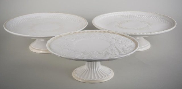 Three Lenox Porcelain Cake Stands: Each with raised decoration on a pedestal base. Comprising a pair and a single. Height 4 1/2 inches.