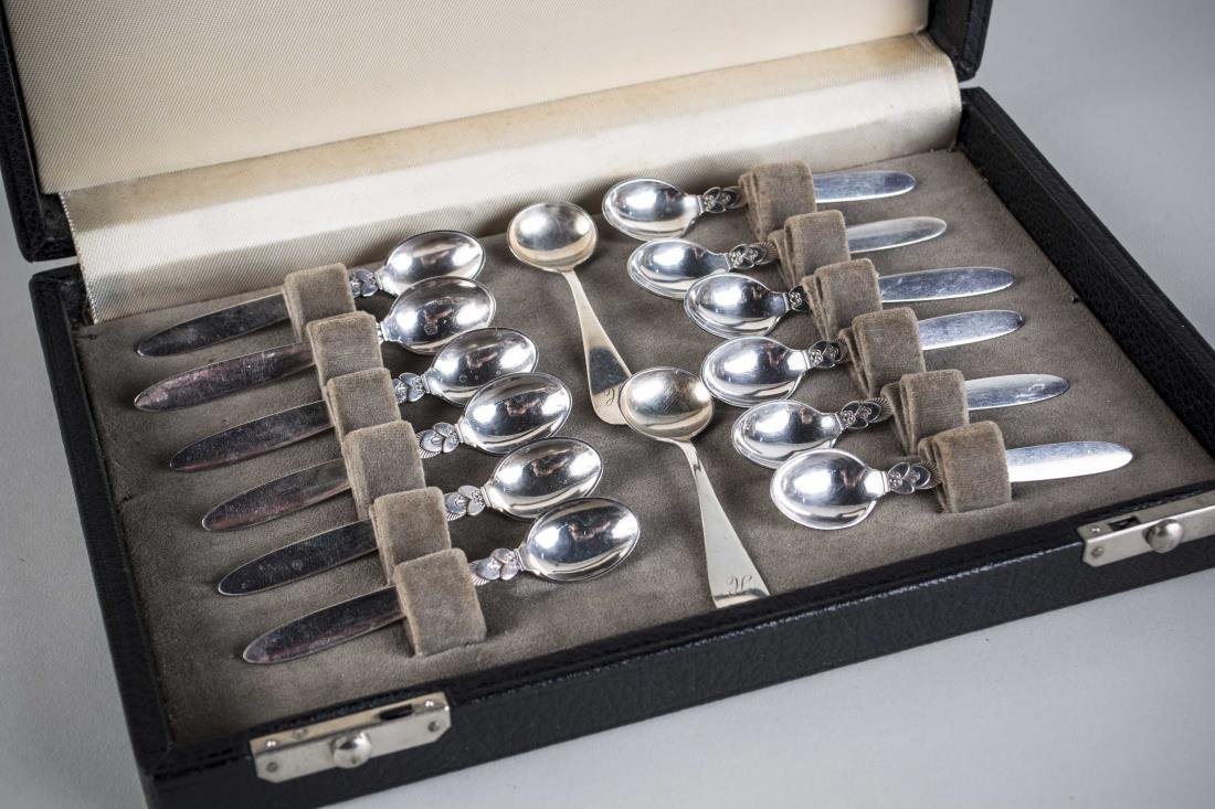 Georg Jensen Set of Coffee Spoons: Boxed set of twelve Cactus pattern spoons; together with a pair of salt cellar spoons. Total 240 grams, 8 ounces.