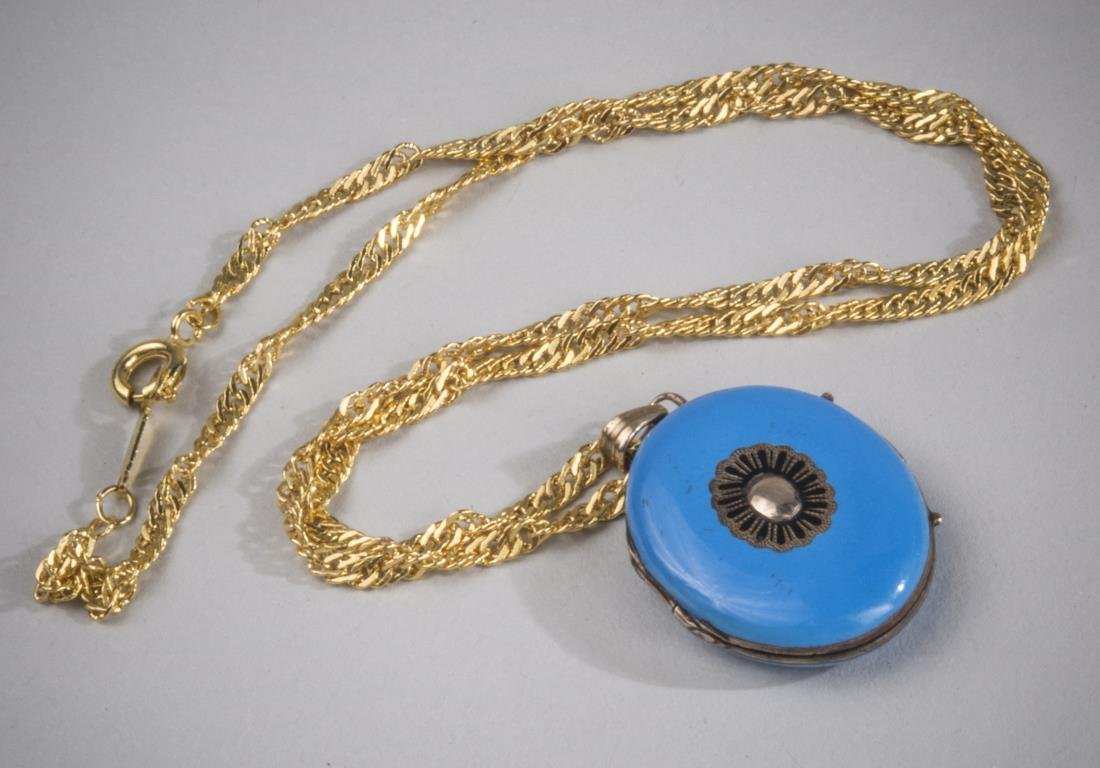 Enamel Locket on Gold Chain: Light blue enamel locket on an 18k gold filled chain. Length 16 inches.