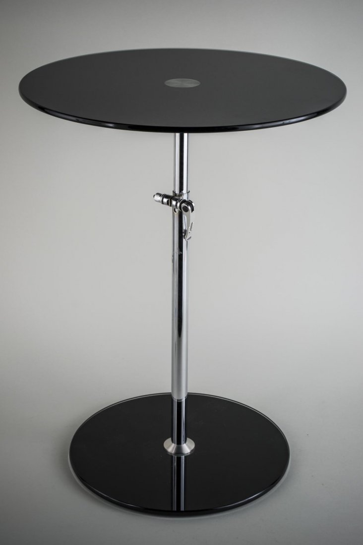 Modern Pedestal Table: Circular top on a chrome support. Height 24 inches, diameter 18 inches.