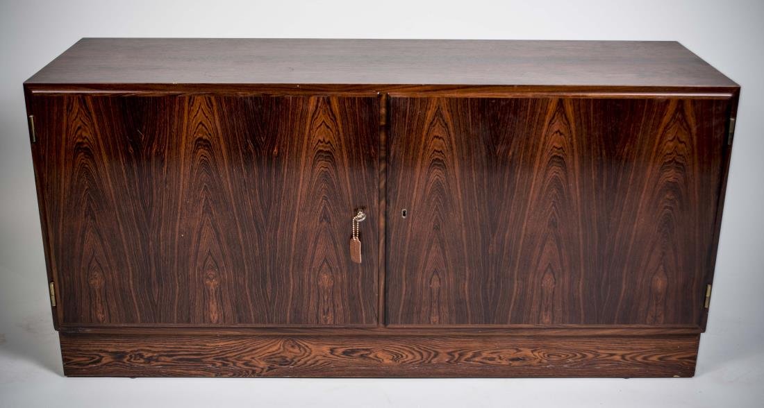 Arne Vodder Style Danish Modern Rosewood Credenza: With Danish Furnituremaker's Quality Control brand on back and metal badge in cabinet, rectangular top over two cabinet doors, opening to adjustable shelves. Height 26 inches, width 54 1/2 inches, dep