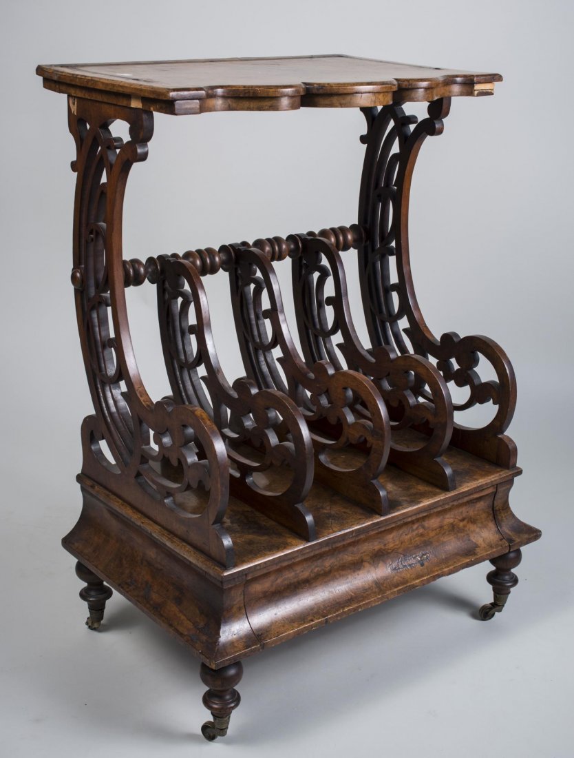 Magazine Rack: 19th century. Shaped rectangle top on two openwork scroll support and openwork scroll dividers over a single drawer on turned legs and brass castors. Height 35 inches, width 26 inches, depth 17 inches