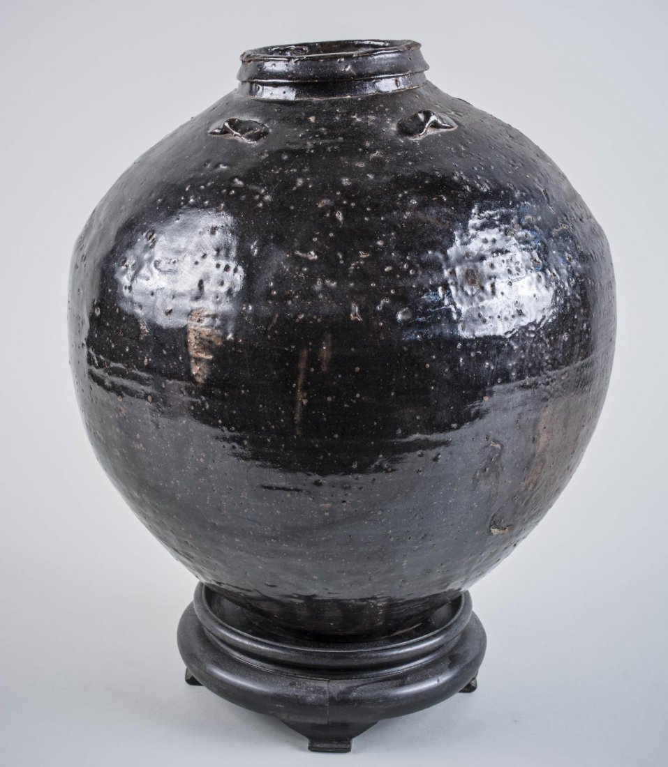 A Chinese Henan Black Pottery Jug: Food storage jar with strap handles on the shoulder (one missing). 19th century or earlier. Height 15 inches.