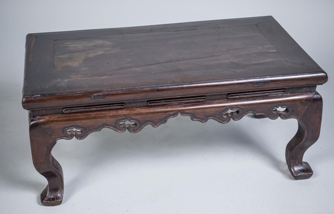 Chinese Hardwood Kang Low Table: Rectangular top on modified elephant trunk legs. 19th century. Height 12 inches, width 27 inches, depth 16 inches.