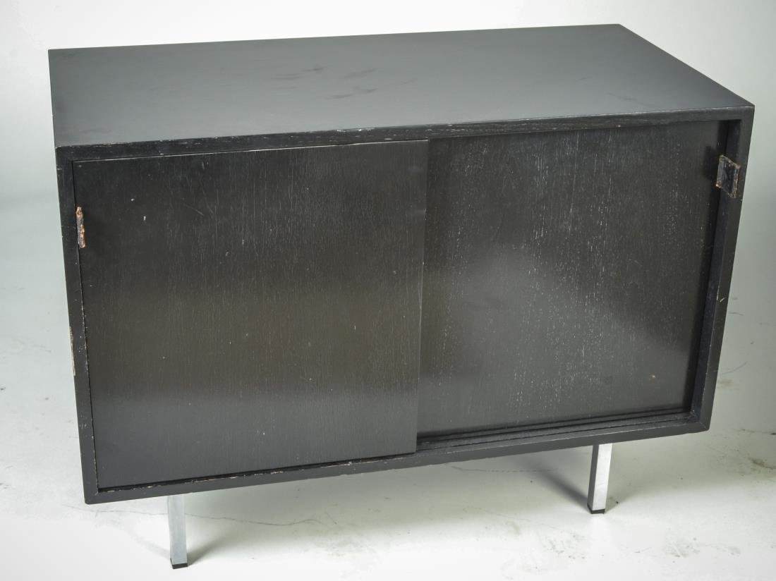 Knoll Mid Century Ebonized Cabinet: Rectangular top, over sliding doors, steel legs, Knoll label. Height 27 inches, width 36 inches, depth 18 inches.