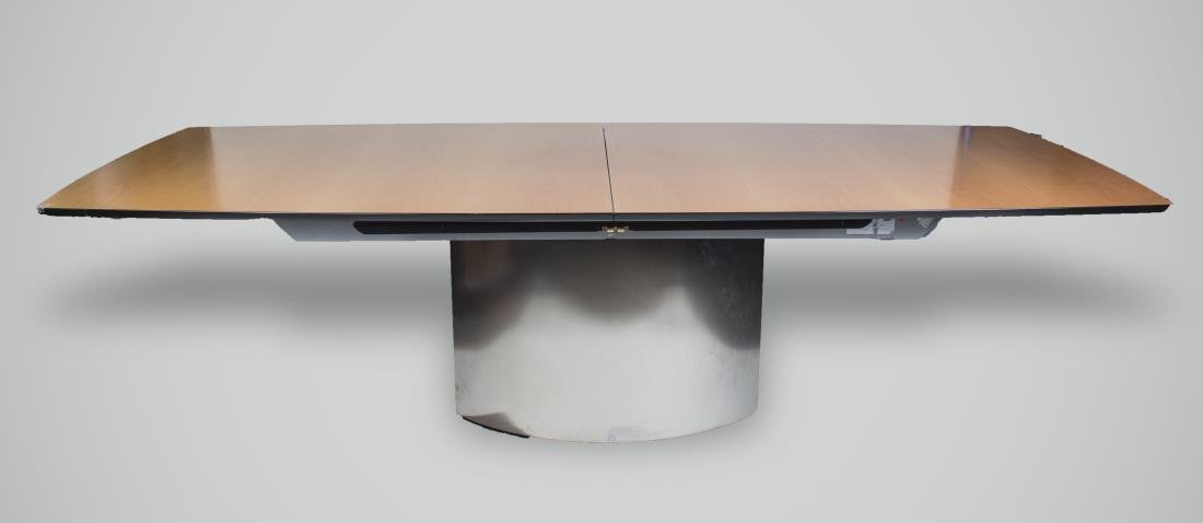 Adler Beech Modern Dining Table: Boat shaped top on a brushed steel pedestal base. Closed. Height 30 inches, width 8 feet 9 inches, depth 45 inches. Provenance: ddc, Madison Av, New York NY 2002