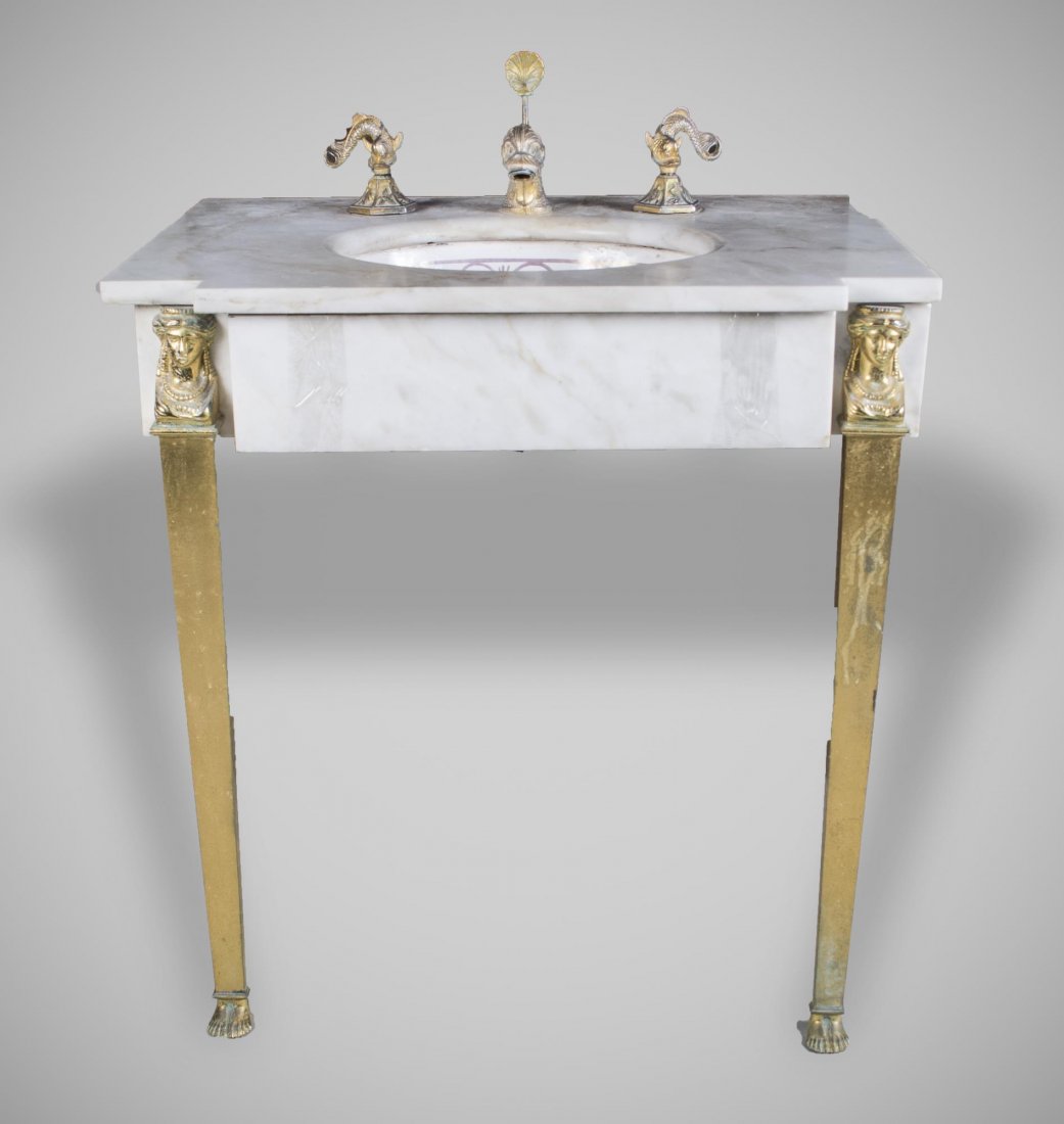 Sherle Wagner Porcelain Sink: Gilt Bronze hardware, marble counter and parcel gilt bowl. Height 30 inches, width 29 inches, depth 22 inches.