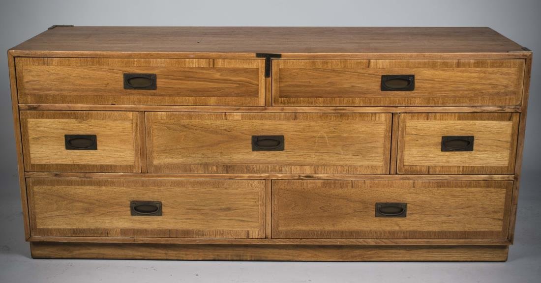 Campaign Style Dresser: Rectangular top over three rows of two or three drawers, plinth base. Height 29 inches, width 5 feet 4 inches, depth 20 inches.