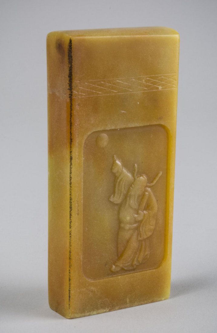 Soapstone Seal: Decorated with a figure of a man in long robe. Height 4 1/2 inches.
