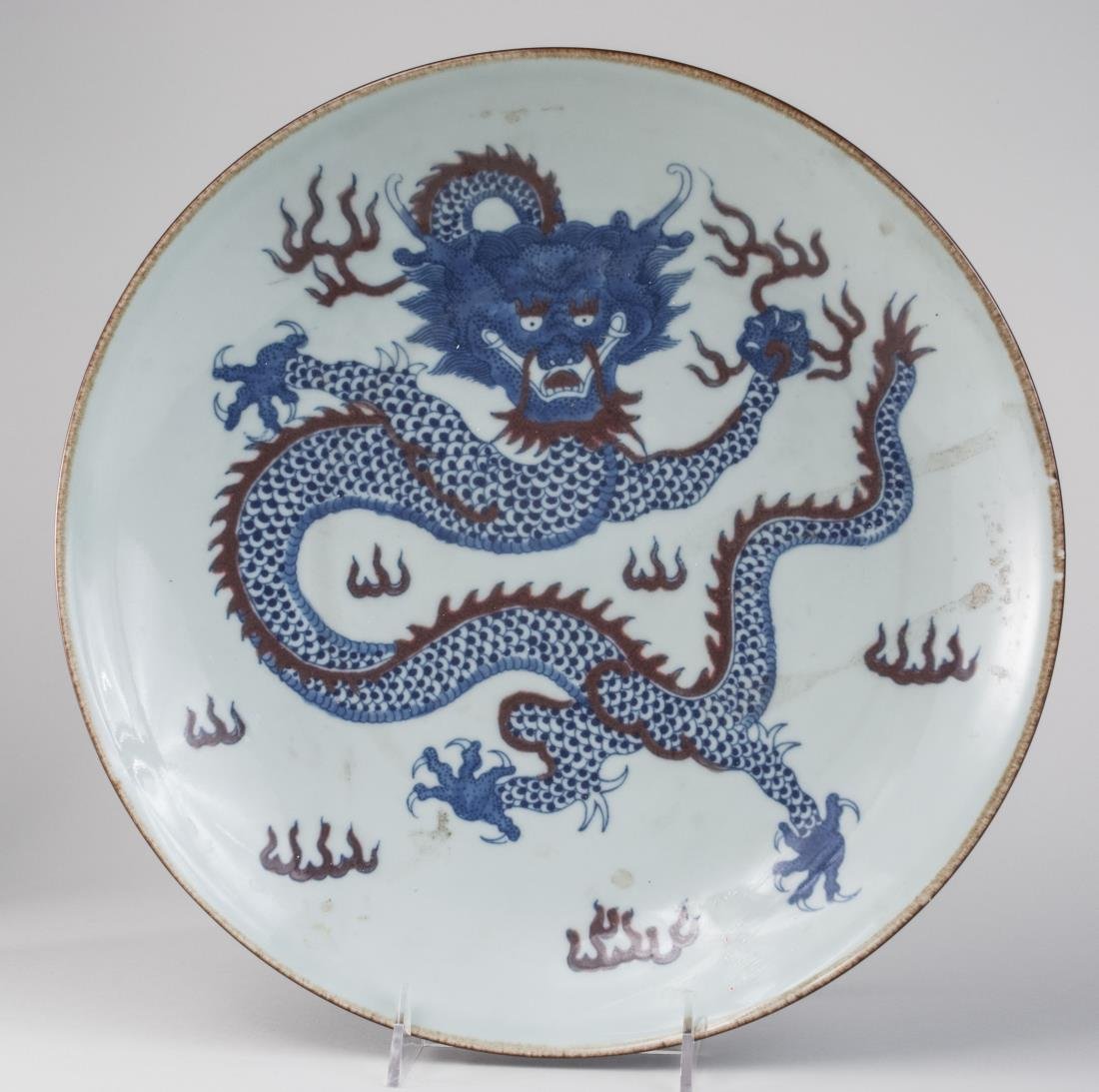 Chinese Porcelain Charger: Qing mark, decorated with a dragon. Height 3 inches, diameter 13 inches.