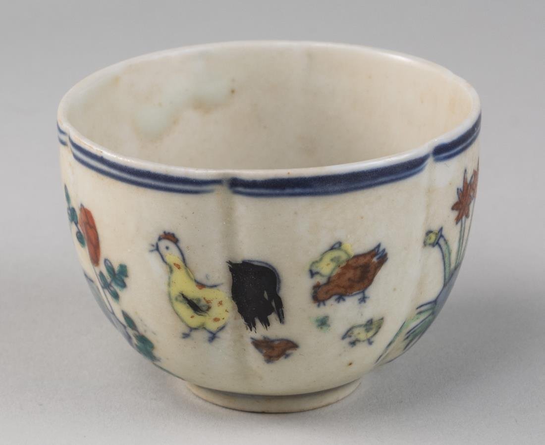 Chinese Porcelain Tea Bowl: Ming dynasty mark, decorated with flowers and animals. Height 2 inches, diameter 3 inches.